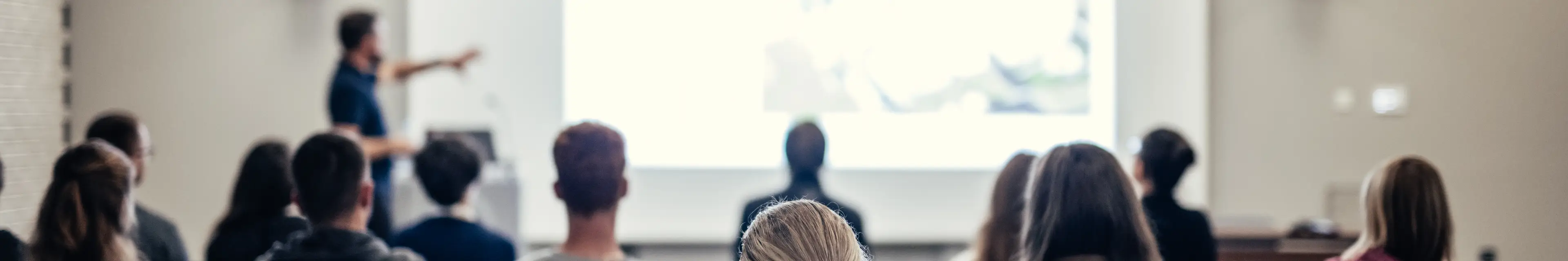 speaker-giving-talk-conference-hall-business-event-rear-view-unrecognizable-people